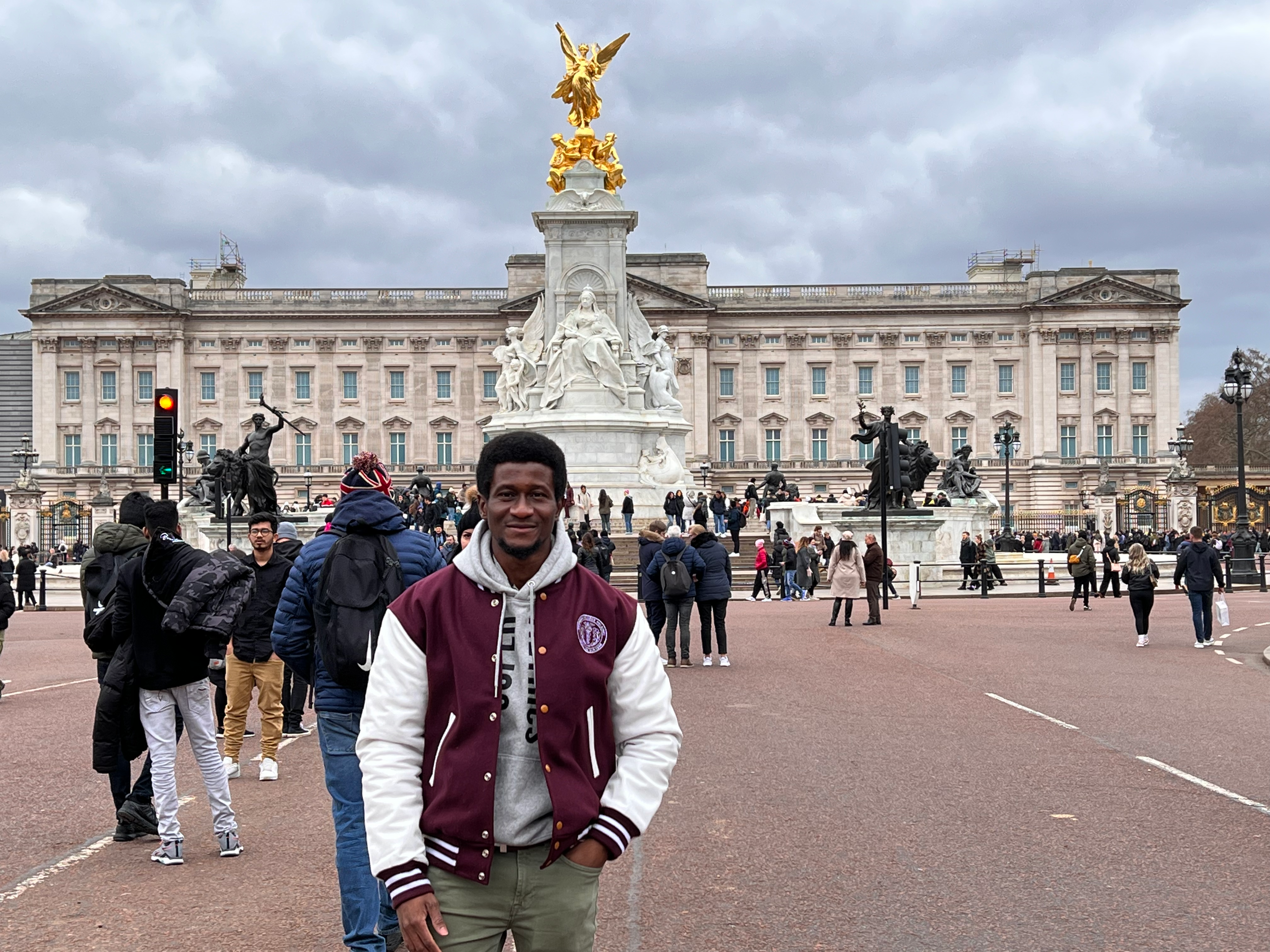 A man in the front of Buckingham Palace